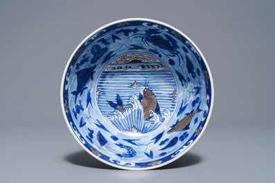 A rare Chinese blue and underglaze red bowl with carps and marine animals, Xuande mark, Kangxi